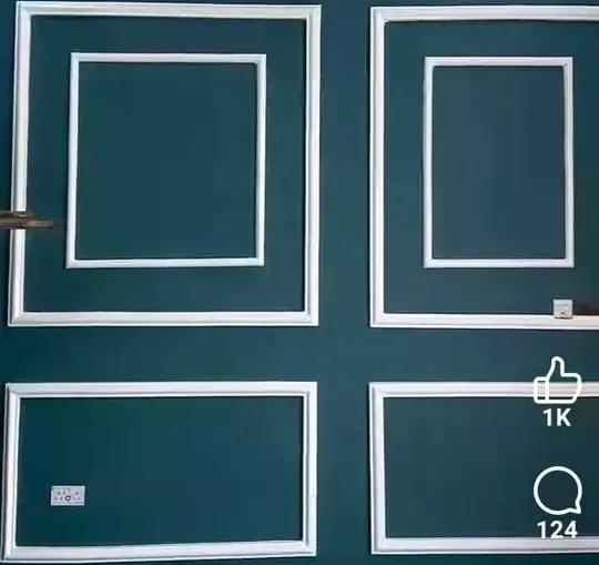 Teal wall with white wainscoting molding panels in geometric arrangement