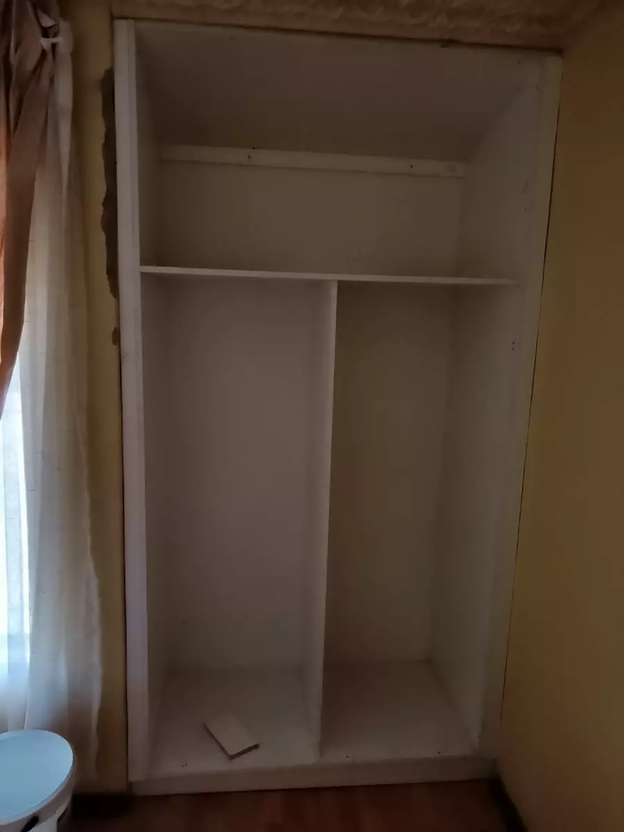 Built-in white wardrobe frame installed against a wall