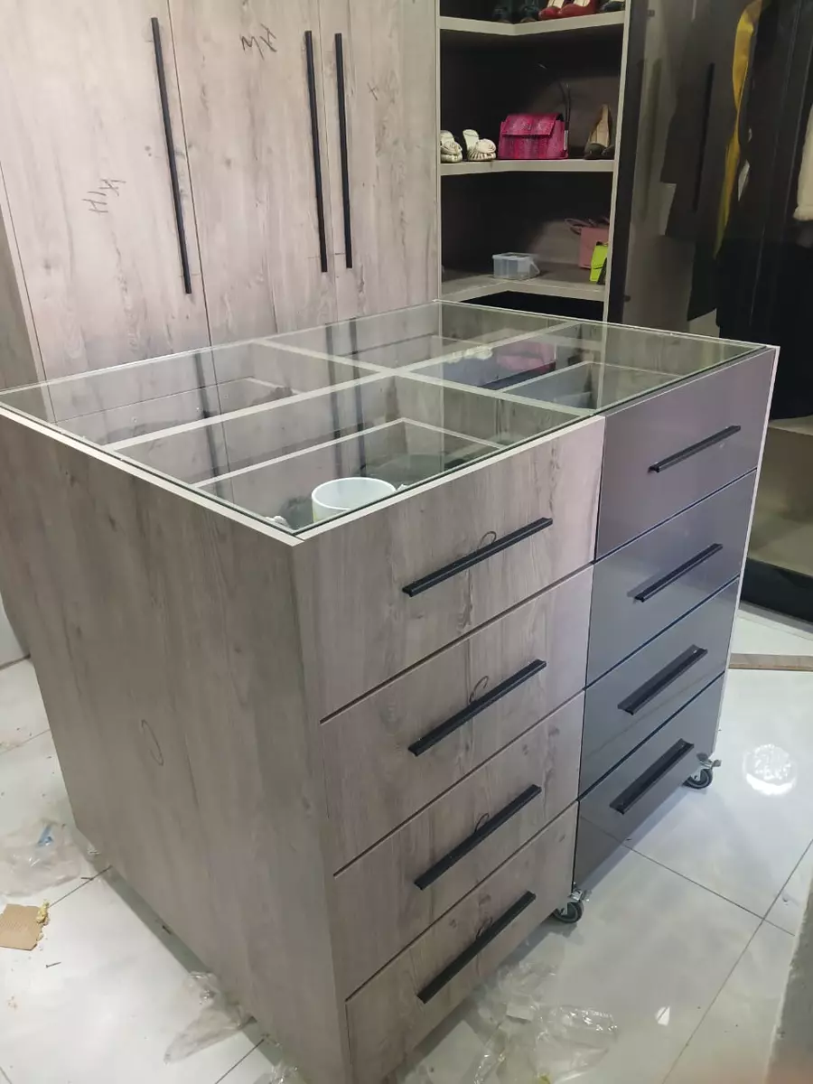 Custom wardrobe island with glass top and drawers