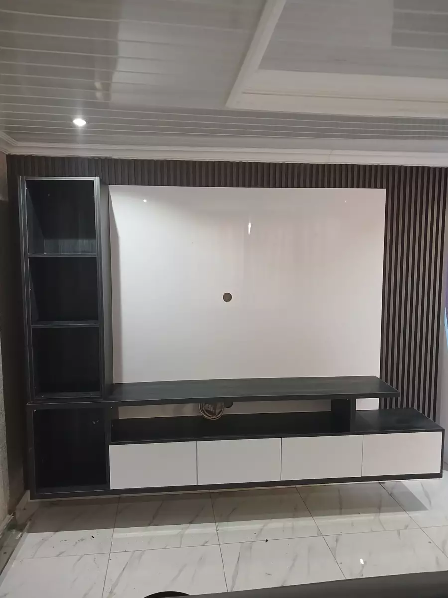 Custom-built entertainment center and TV wall unit with dark slatted paneling